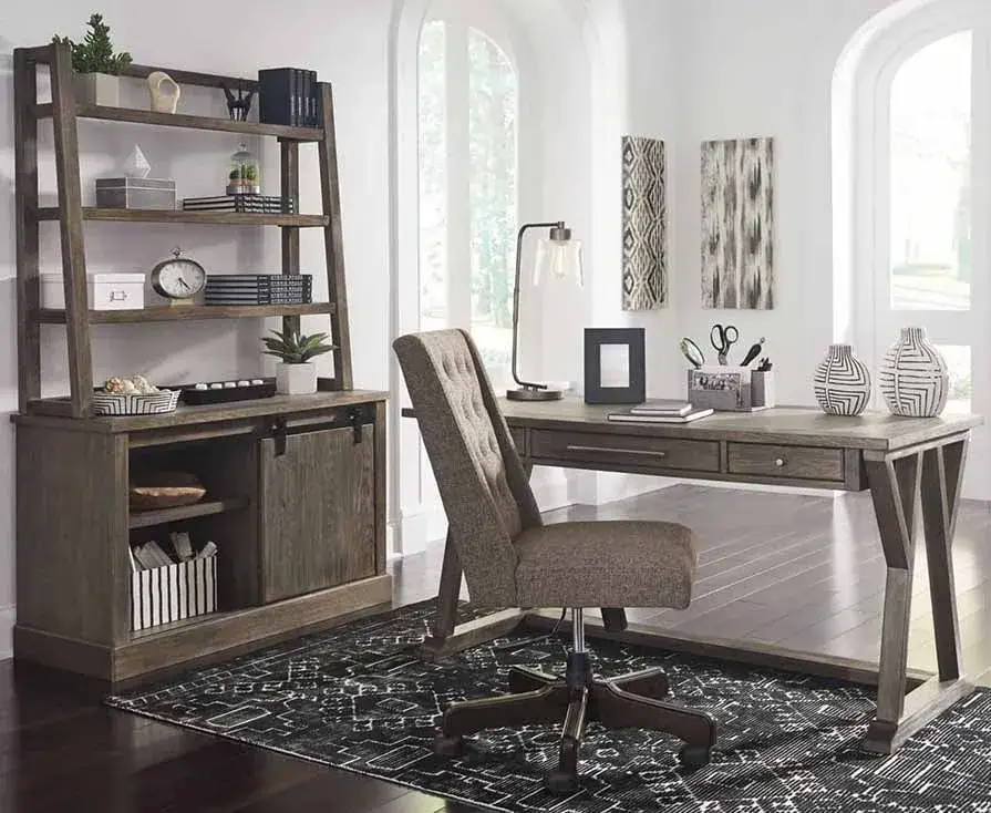 Modern home office with desk and bookshelf.
