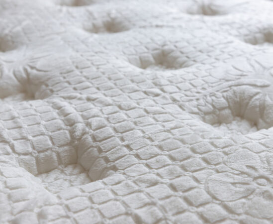 Close-up of textured white mattress surface