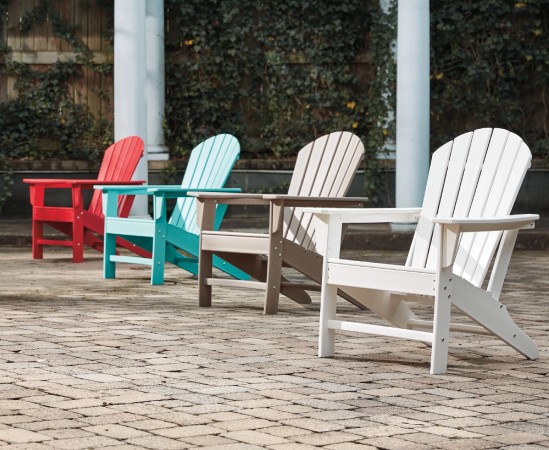 Colorful Adirondack chairs on stone patio